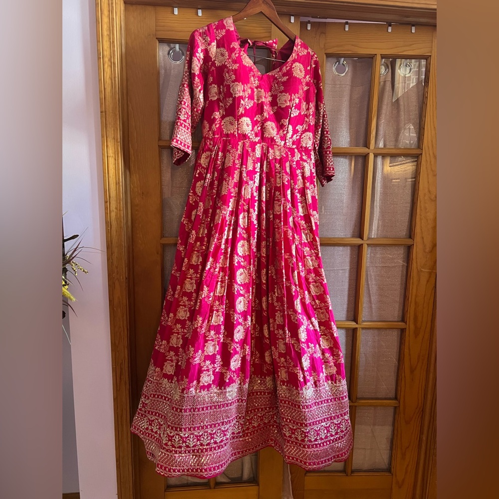 Beautiful pink gown with golden embroidery and sequins on sleeves and bottom.